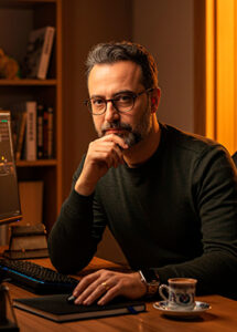 Portrait of Mehmet Yildirim, Senior iGaming & Slot Reviewer at WinTops Games Ltd, working at his desk